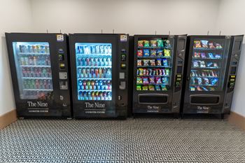Four vending machines are lined up in a row.